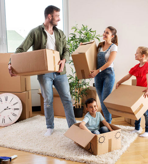 A happy family moving into a new home, surrounded by cardboard boxes